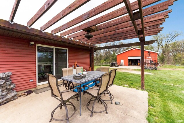5155 E 200 N, Columbia City, IN 46725 - view of patio with a detached garage, a pergola, an outbuilding, and outdoor dining space