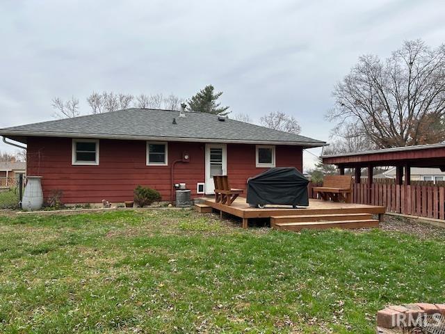 back of property featuring central AC unit, fence, a yard, and a deck