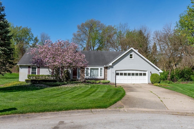 view of front facade with a garage, driveway, and a front yard