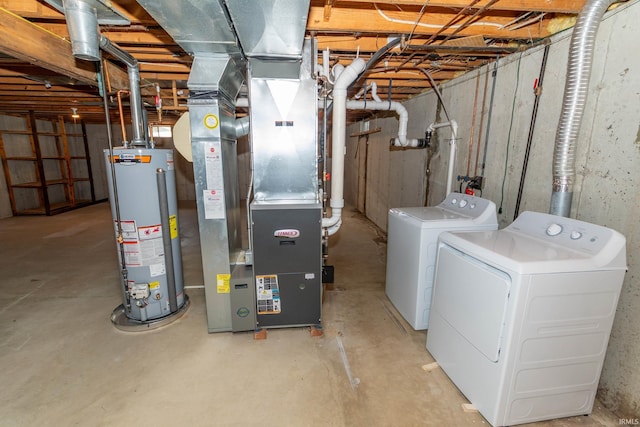 unfinished basement with heating unit, water heater, and washing machine and clothes dryer