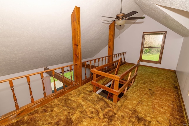 bonus room with carpet floors, a ceiling fan, a textured ceiling, and lofted ceiling