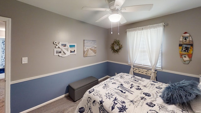 carpeted bedroom featuring baseboards and ceiling fan
