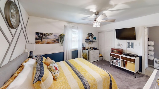 carpeted bedroom featuring a ceiling fan and a closet