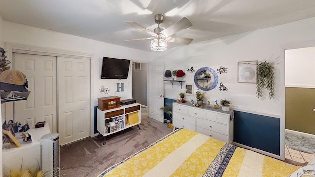 carpeted bedroom with a ceiling fan, baseboards, visible vents, and a closet