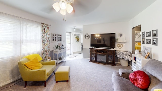 carpeted living area featuring ceiling fan