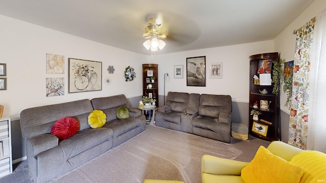 carpeted living room featuring a ceiling fan