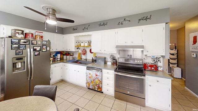 kitchen featuring a sink, light tile patterned flooring, under cabinet range hood, a ceiling fan, and appliances with stainless steel finishes