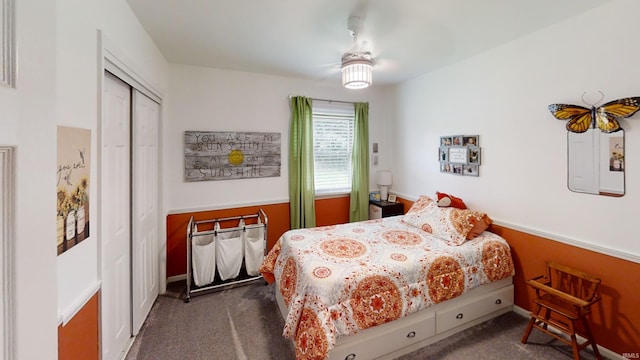 bedroom with a closet, a ceiling fan, and dark colored carpet