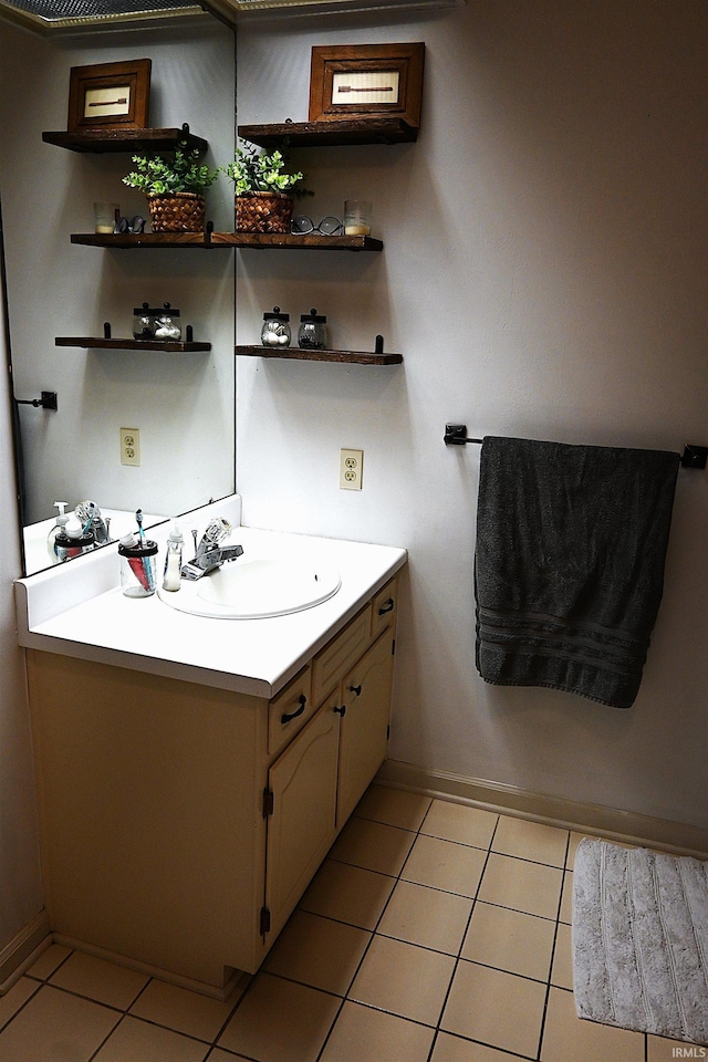 bathroom with tile patterned floors, baseboards, and vanity