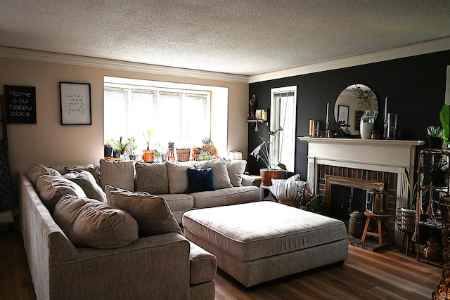 living room with crown molding, a textured ceiling, a brick fireplace, and wood finished floors