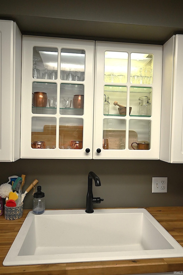 room details featuring a sink and white cabinets