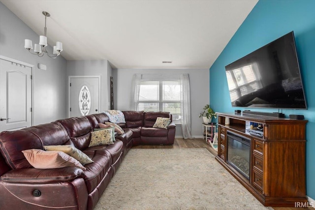 359 Limestone Ct, Lafayette, IN 47909 - living area featuring visible vents, wood finished floors, baseboards, lofted ceiling, and an inviting chandelier