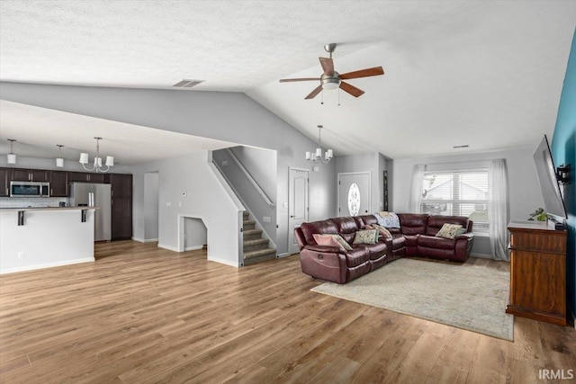 359 Limestone Ct, Lafayette, IN 47909 - living room featuring visible vents, stairway, ceiling fan with notable chandelier, lofted ceiling, and light wood-style floors
