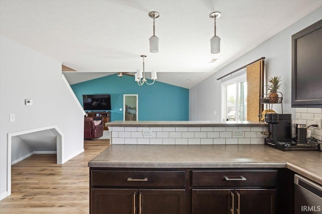 359 Limestone Ct, Lafayette, IN 47909 - kitchen featuring a peninsula, lofted ceiling, dark brown cabinets, open floor plan, and light wood-style flooring