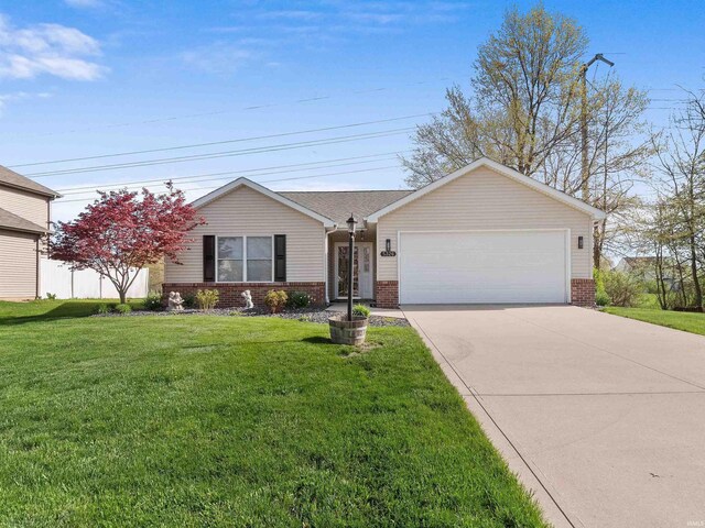 5326 Dennison Dr, Fort Wayne, IN 46835 - ranch-style house featuring concrete driveway, brick siding, a front lawn, and a garage