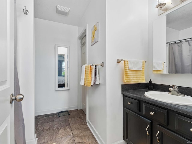 5326 Dennison Dr, Fort Wayne, IN 46835 - bathroom featuring baseboards, stone finish floor, vanity, and visible vents