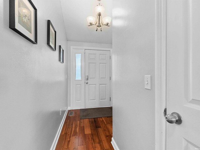 5326 Dennison Dr, Fort Wayne, IN 46835 - entryway with baseboards, dark wood-type flooring, a chandelier, and visible vents