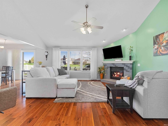 5326 Dennison Dr, Fort Wayne, IN 46835 - living room with a brick fireplace, ceiling fan, wood finished floors, and vaulted ceiling