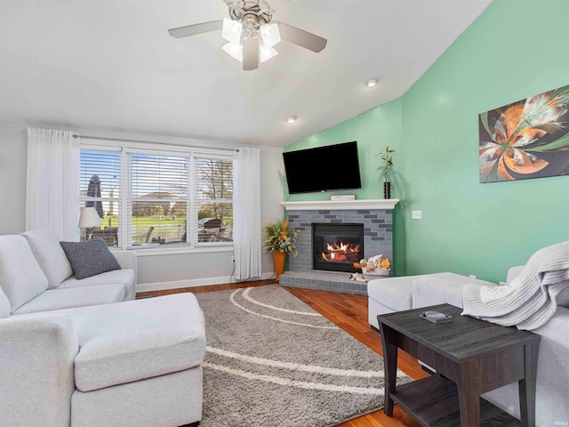 5326 Dennison Dr, Fort Wayne, IN 46835 - living room featuring ceiling fan, a fireplace, vaulted ceiling, wood finished floors, and baseboards