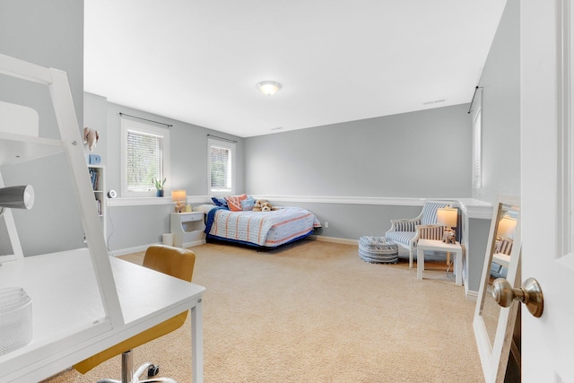 bedroom featuring baseboards and carpet flooring