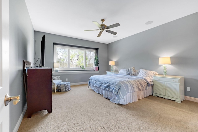 bedroom with baseboards, a ceiling fan, and light colored carpet