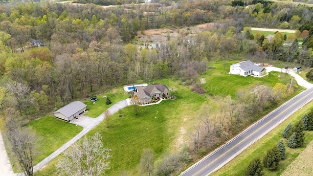 drone / aerial view with a wooded view