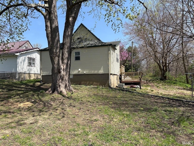 view of side of property featuring a wooden deck