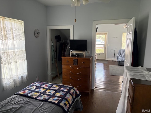 bedroom with baseboards and dark wood finished floors