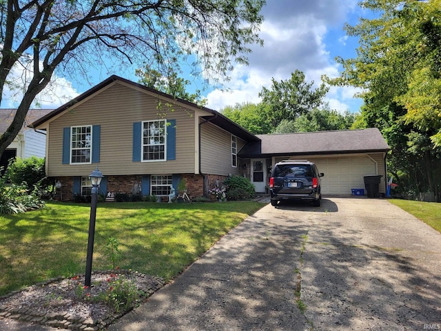 tri-level home with a garage, driveway, a front lawn, and brick siding