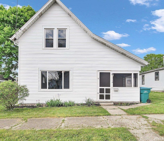 back of house featuring a sunroom