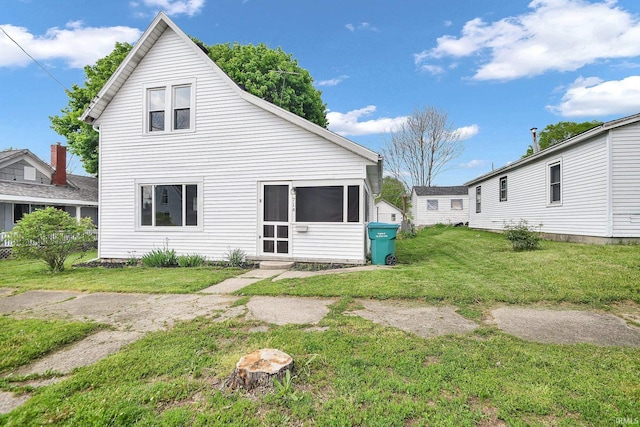 rear view of property with a lawn