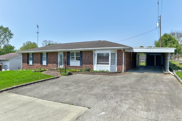 ranch-style house with brick siding, a front lawn, driveway, and a carport