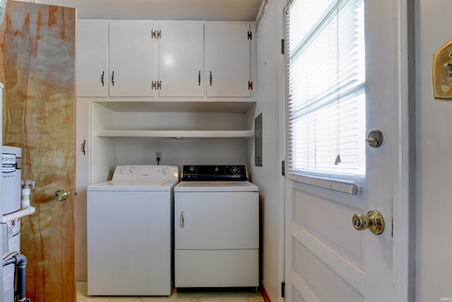 clothes washing area featuring cabinet space and independent washer and dryer