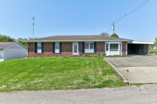 ranch-style house with brick siding, aphalt driveway, a front lawn, and an attached carport