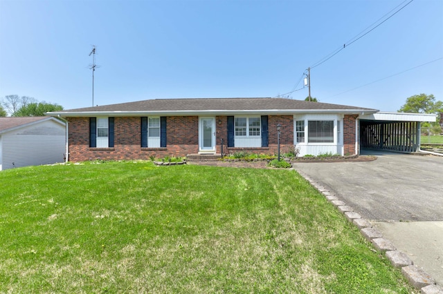 single story home with a carport, a front yard, driveway, and brick siding