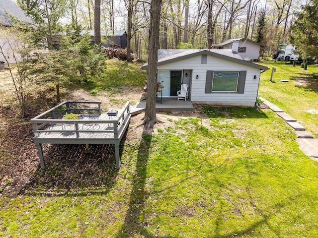 exterior space featuring a lawn and a wooden deck