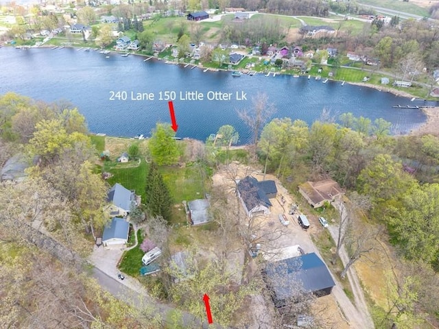 drone / aerial view with a residential view and a water view