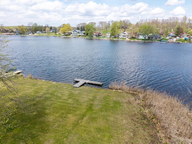 view of water feature with a residential view and a dock