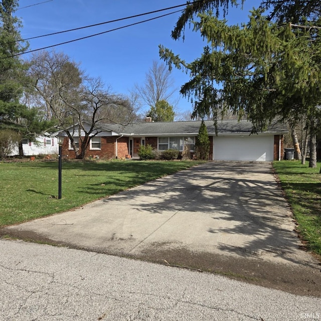 ranch-style house with driveway, a chimney, a front yard, brick siding, and an attached garage