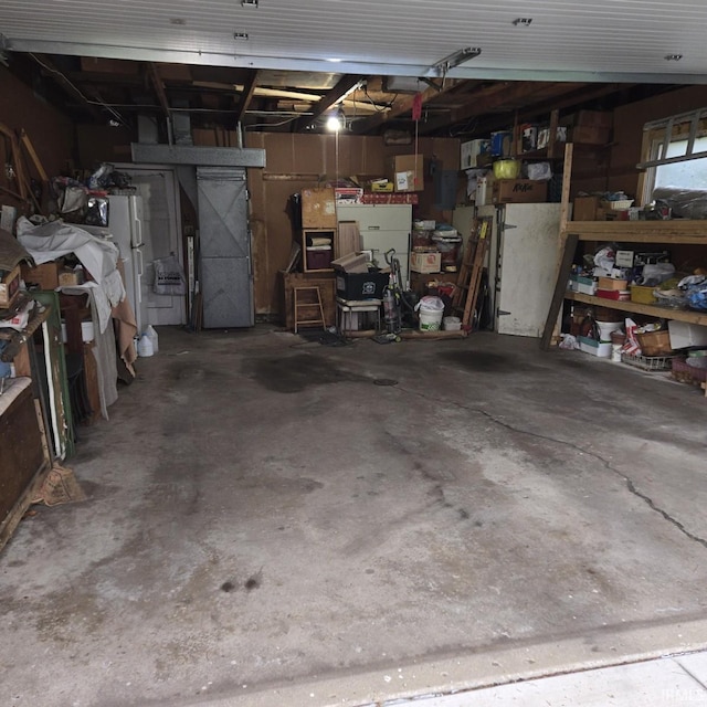 garage with heating unit and freestanding refrigerator