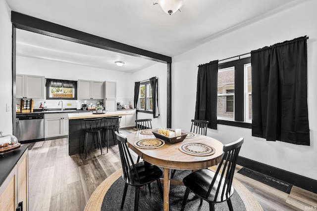 1314 Miner St, South Bend, IN 46617 - dining space featuring light wood-style floors, visible vents, and beamed ceiling