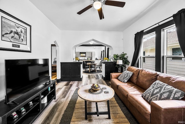 1314 Miner St, South Bend, IN 46617 - living area with arched walkways, ceiling fan, and wood finished floors