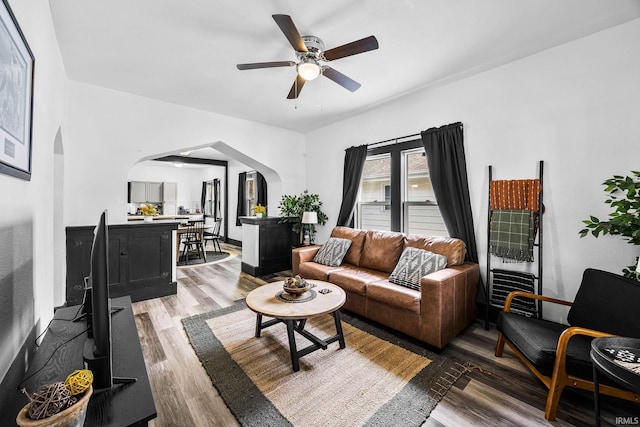 1314 Miner St, South Bend, IN 46617 - living area with arched walkways, ceiling fan, and light wood-type flooring