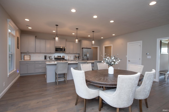 dining area with recessed lighting, dark wood finished floors, and baseboards