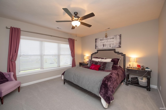 bedroom with baseboards, carpet flooring, ceiling fan, and visible vents