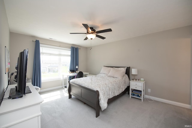 bedroom featuring baseboards, a ceiling fan, and light colored carpet