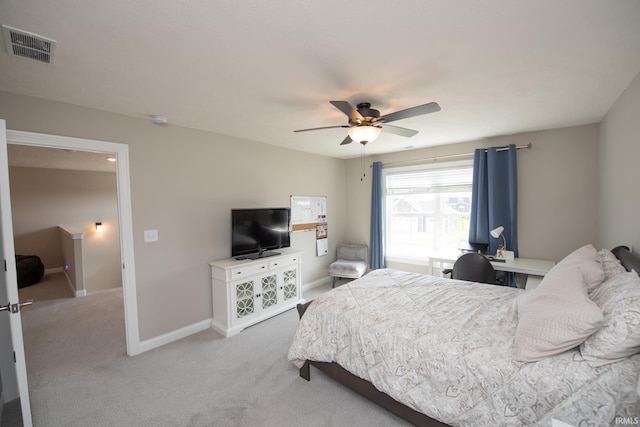 bedroom with visible vents, baseboards, ceiling fan, and light carpet
