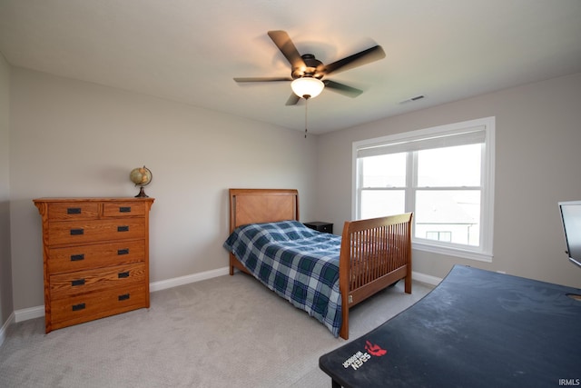 bedroom with a ceiling fan, baseboards, visible vents, and light carpet