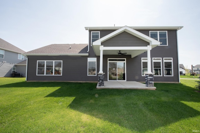 rear view of property with a ceiling fan, a patio area, central air condition unit, and a yard
