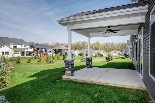 view of yard with a ceiling fan, a patio area, playground community, and a residential view